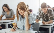 Pretty,Caucasian,Girl,High,School,Student,Doing,Exam,At,Classroom.