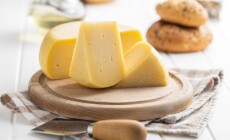 Block,Of,Hard,Cheese.,Sliced,Cheese,On,Cutting,Board.