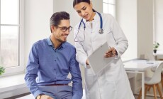 Professional,Female,Doctor,Smiles,And,Shows,Positive,Examination,Results,To