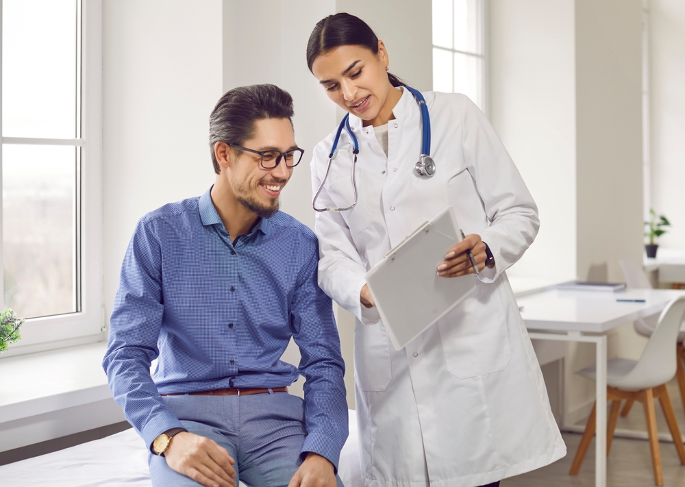 Professional,Female,Doctor,Smiles,And,Shows,Positive,Examination,Results,To