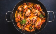Baked,Chicken,Drumsticks,With,Vegetables,,Casserole,Dish,On,Black,Background