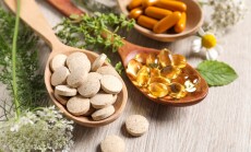 Different,Pills,,Herbs,And,Flowers,On,Wooden,Table,,Closeup.,Dietary