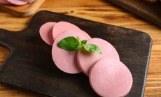 Board,With,Slices,Of,Tasty,Boiled,Sausage,And,Basil,On