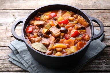 Delicious,Stew,With,Vegetables,In,Pot,On,Wooden,Table,,Closeup