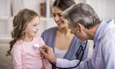 Pediatrician,Checks,Breath,Stethoscope,A,Little,Girl,In,The,Arms