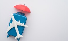 Travel,Insurance,Business,Concept.,Red,Umbrella,Cover,Airplane,And,Suitcases