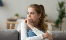 Head,Shot,Woman,Anxious,Worried,Woman,Sitting,On,Couch,At
