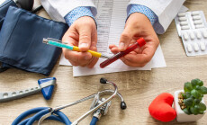 Doctor,During,Consultation,Held,In,His,Hand,And,Shows,Patient