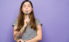 Hungry,Young,Woman,With,Her,Eyes,Closed,Enjoying,A,Spoonful