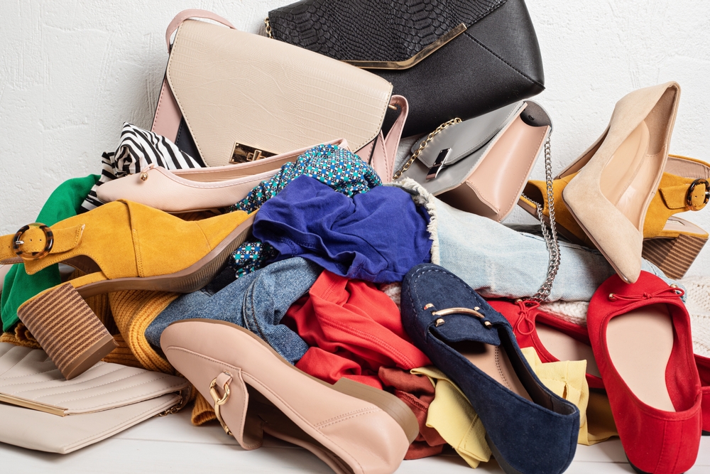 Fast,Fashion,Background,With,Pile,Of,Cheap,,Low,Quality,Clothes.