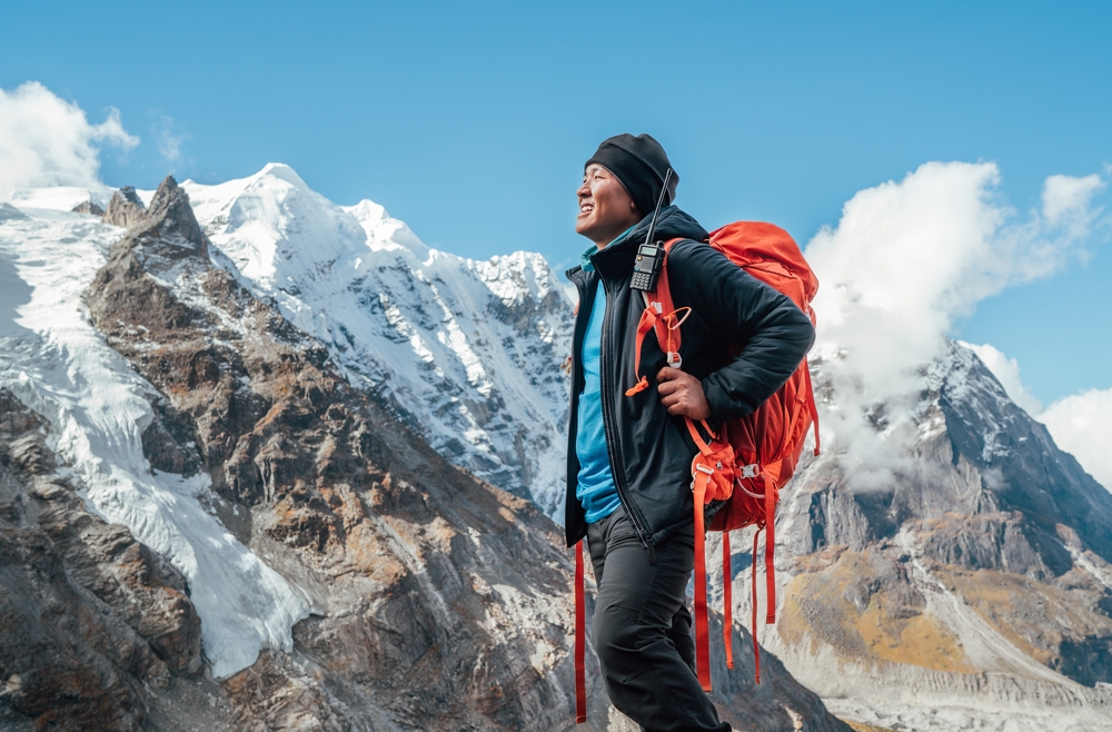 Portrait,Of,Smiling,Sherpa,Man,With,Backpack,Enjoying,Mountain,Views