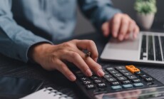 Businessman,Using,Calculator,Bookkeeping,Payroll,And,Budget,Tax.,Business,Document
