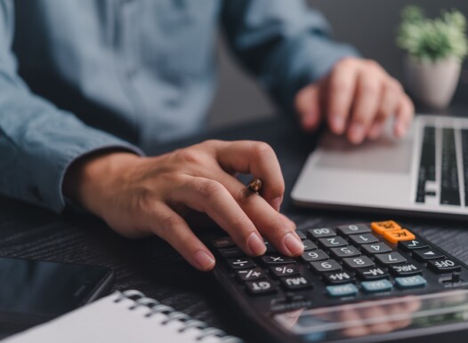 Businessman,Using,Calculator,Bookkeeping,Payroll,And,Budget,Tax.,Business,Document