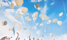 Several,Baloons,Flying,In,Blue,Sky