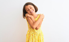 Young,Beautiful,Child,Girl,Wearing,Yellow,Floral,Dress,Standing,Over