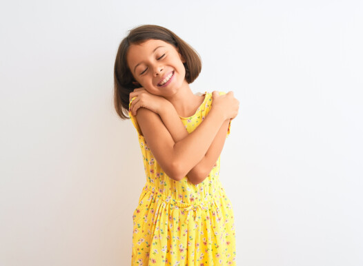 Young,Beautiful,Child,Girl,Wearing,Yellow,Floral,Dress,Standing,Over