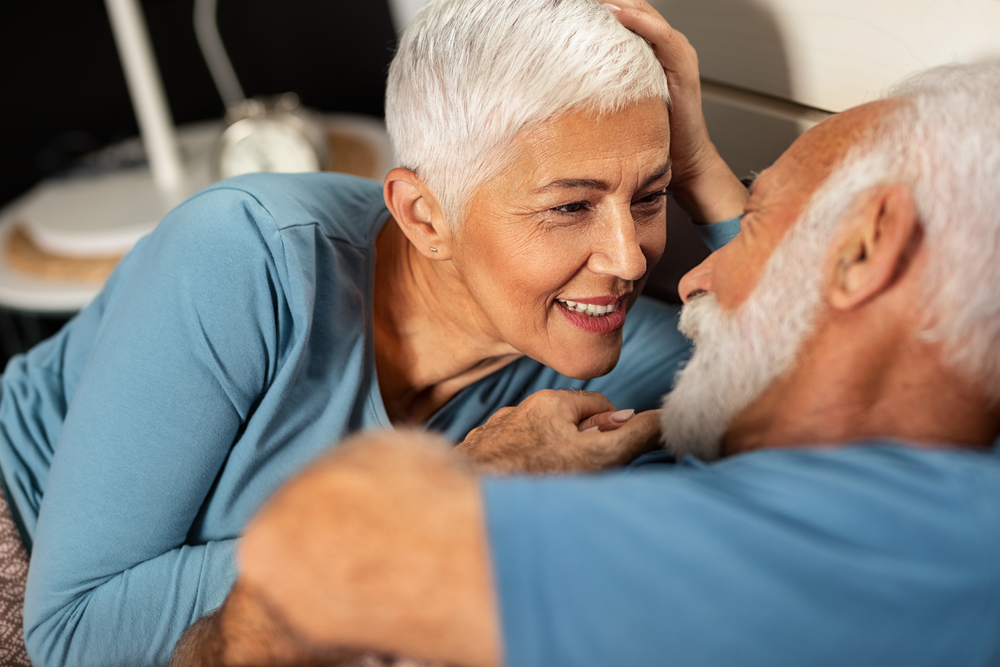 Happy,Senior,Couple,Lying,Together,In,Bed