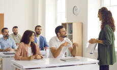 College,Teacher,Or,Business,Course,Trainer,Having,Discussion,With,Group