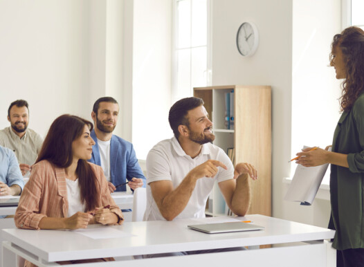 College,Teacher,Or,Business,Course,Trainer,Having,Discussion,With,Group