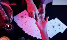 Fortune,Teller,Pointing,At,Love,Line,On,Palm,Of,Female