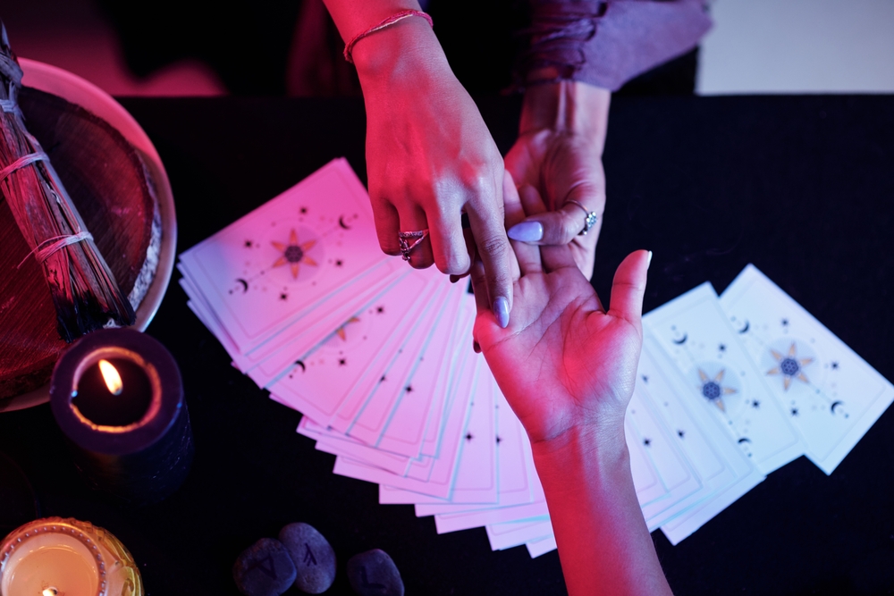 Fortune,Teller,Pointing,At,Love,Line,On,Palm,Of,Female