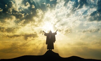 Silhouette,Of,Jesus,Praying,With,Raised,Hands,On,A,Mount