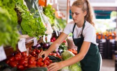 Blonde,Female,Seller,In,Uniform,Working,In,Supermarket,At,Her