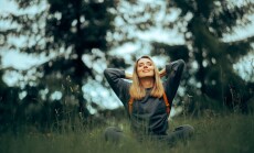 Happy,Millennial,Woman,Relaxing,In,The,Grass,Enjoying,Nature.,Carefree