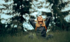 Happy,Millennial,Woman,Relaxing,In,The,Grass,Enjoying,Nature.,Carefree