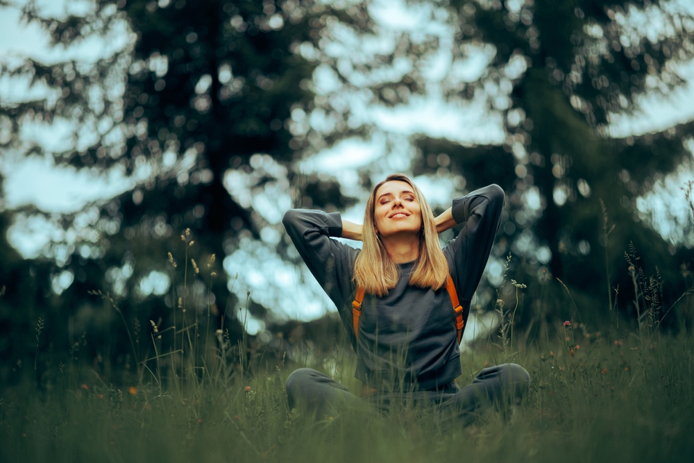 Happy,Millennial,Woman,Relaxing,In,The,Grass,Enjoying,Nature.,Carefree