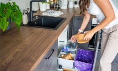 Woman,Throwing,Trash,Into,Household,Bins,For,Waste,Sorting,In