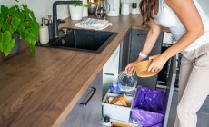 Woman,Throwing,Trash,Into,Household,Bins,For,Waste,Sorting,In