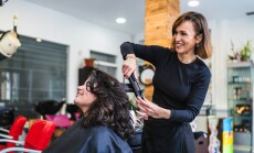 A,Hairdresser,Uses,A,Curling,Iron,To,Curl,A,Client's