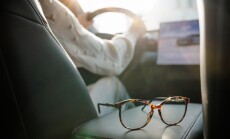Eyeglasses,On,Car,Seat,With,Driver,In,Background,And,Sunlight