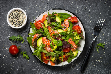 Salmon,Salad,With,Green,Leaves,,Avocado,And,Tomato,On,Black