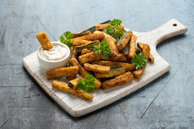 Crispy,Zucchini,Fries,With,Sauce,In,White,Wooden,Board