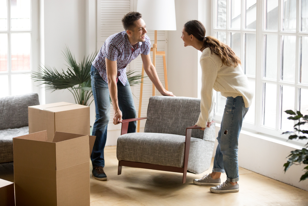 Smiling,Couple,Carrying,Modern,Chair,Together,Placing,Furniture,Moving,Into