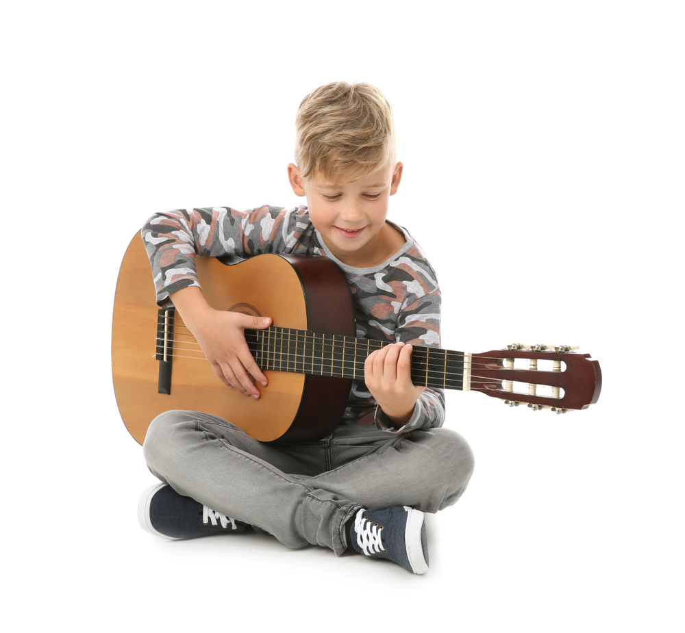 Little,Boy,Playing,Guitar,Isolated,On,White