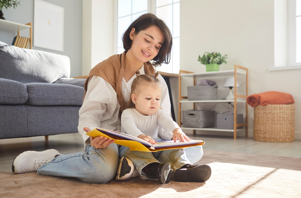 Loving,Happy,Young,Mother,,Babysitter,And,Little,Child,Reading,Book,