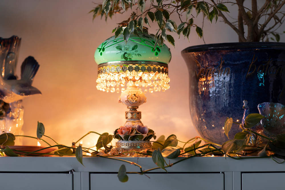 A,Vintage,Green,Lamp,Surrounded,By,House,Plants,In,A