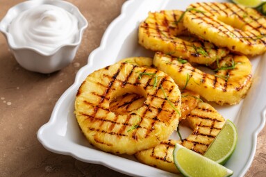 Grilled,Pineapple,With,Lime,Honey,Glaze,,Lime,Zest,And,Whipped