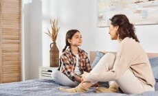 Two,Women,,A,Mother,And,Daughter,,Sit,On,A,Bed