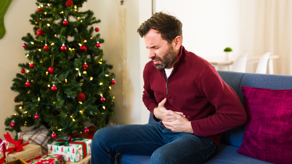 Man,Experiencing,A,Stomach,Ache,After,Eating,Too,Much,While