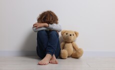 Child,Abuse.,Upset,Boy,With,Toy,Sitting,On,Floor,Near