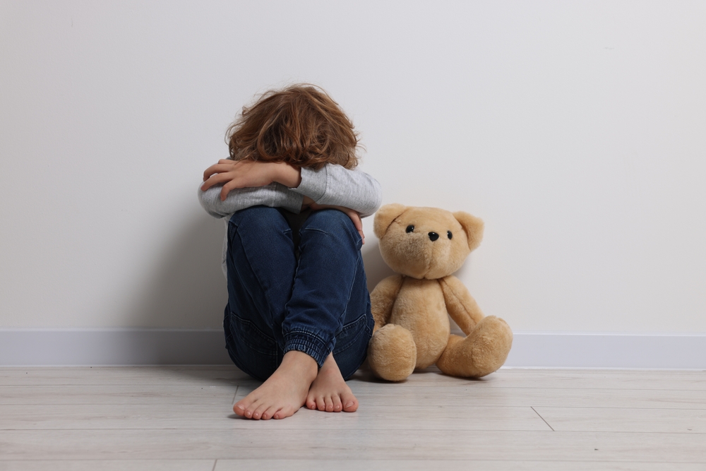 Child,Abuse.,Upset,Boy,With,Toy,Sitting,On,Floor,Near