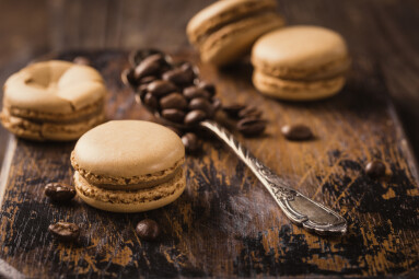French,Coffee,Macaroons,With,Ganache,Filling,And,Spoon,With,Coffee