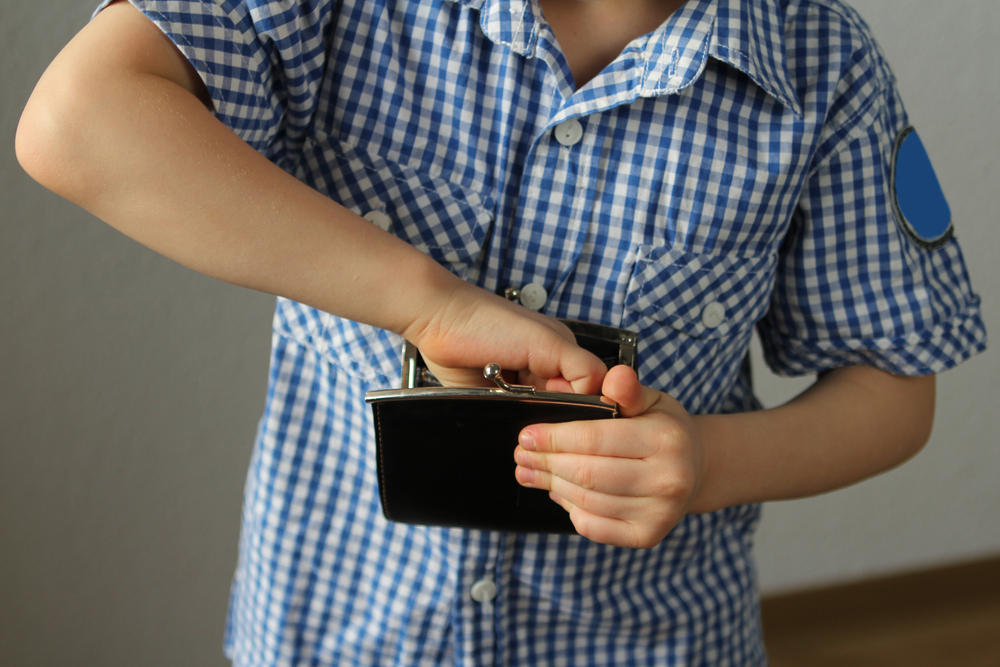 Kid,Holds,A,Wallet,And,Takes,Out,With,His,Hand,