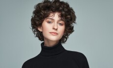 Portrait,Of,Brunette,With,Curls,Wear,High,Neck,Jumper,Isolated