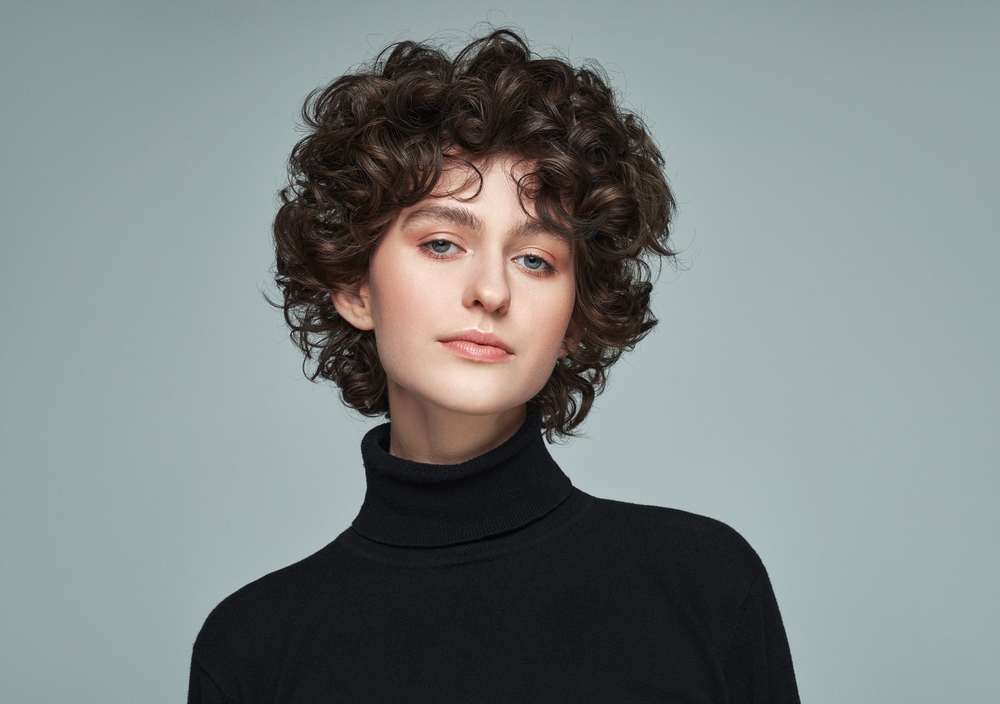 Portrait,Of,Brunette,With,Curls,Wear,High,Neck,Jumper,Isolated