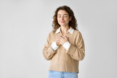 Happy,Pleased,Pretty,Young,Woman,Holding,Hands,On,Chest,Feeling